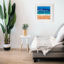 Load image into Gallery viewer, Vast Beach, a painting by young artist Aria Luna, framed and displayed in a modern living room